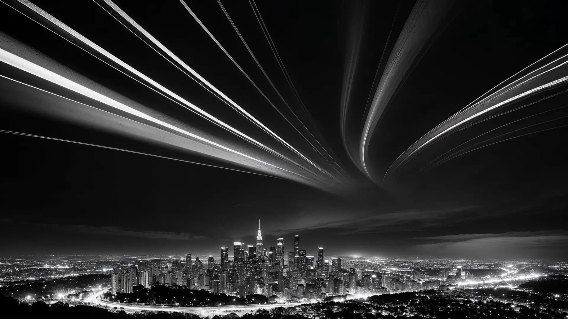 A black and white photograph of a bustling cityscape with light trails